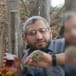 The newest photo of Muhammed Deif (right) holding US dollars and a plastic cup of juice.