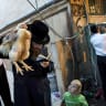 A man performs the ancient Jewish ritual of kaparot