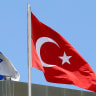 A Turkish flag waves atop the Turkish embassy as an Israeli flag is seen nearby, in Tel Aviv, Israel, June 26, 2016