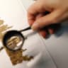 A restorer works on a fragment of the Dead Sea Scrolls in a laboratory at the Israel Museum in Jerusalem