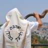 RABBI MOSHE SILVER blows a Yemenite shofar at the Jerusalem Promenade