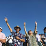 EVANGELICAL CHRISTIAN pilgrims and tourists reach for the sky at a 2019 religious retreat in Nazareth