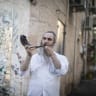 Blowing shofar in Jerusalem's Nahlaot neighborhood