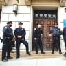 New York police officers stand guard at the door of the Union Temple of Brooklyn, in 2018.