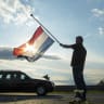  Ronald Visee holds a Netherlands flag flying at half-mast 