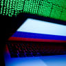  A Russian flag is seen on the laptop screen in front of a computer screen on which cyber code is displayed, in this illustration picture taken March 2, 2018.