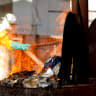  A health worker burns food waste of Ebola patients at an Ebola treatment center (ETC) in Katwa, near Butembo, in the Democratic Republic of Congo, October 5, 2019