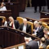  Prime Minister Benjamin Netanyahu, flanked by Defense Minister Yoav Gallant and Justice Minister Yariv Levin, in the Knesset on the day of the vote on the reasonableness law, July 24.