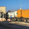  TRUCKS CROSS at Kerem Shalom, the main passage point for goods entering the Gaza Strip from Israel. 