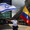  A supporter of Israel holds flags during a protest, following Hamas' biggest attack on Israel in years, in Bogota, Colombia October 9, 2023.