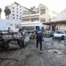 A member of the media walks at the area of Al-Ahli hospital in Gaza City, October 18, 2023