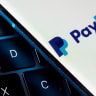  A smartphone with the PayPal logo is placed on a laptop in this illustration taken on July 14, 2021.