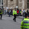  Police officers keep guard outside the Rolls Building of the High Court ahead of the appearance of Britain's Prince Harry in London, June 6, 2023.