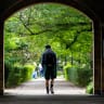  People walk on the grounds of the University of Toronto in Toronto, Ontario
