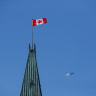   Royal Canadian Mounted Police (RCMP) helicopter flies past the Peace Tower on Parliament Hill, during the visit of U.S. President Joe Biden, in Ottawa, Ontario, Canada March 24, 2023.