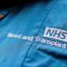 NHS Blood and Transplant embroidery seen on the uniform of a member of staff, following the announcement of the re-balloting voted in the long-running dispute over pay and staffing, in London, Britain, February 18, 2023.
