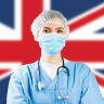  Portrait of UK NHS EMS caucasian hospital frontline ICU GP doctor in PPE Personal Protective Equipment,Great Britain flag background,COVID-19 virus disease crisis,Coronavirus global worldwide pandemic