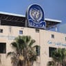  A damaged sign is pictured at the headquarters of UNRWA, following an Israeli raid, amid the Israel-Hamas conflict, in Gaza City, July 12, 2024.