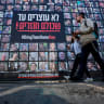  People walk past posters of hostages kidnapped during the deadly October 7 2023 attack by Hamas, ahead of a ceasefire between Israel and Hamas, in Jerusalem, January 16, 2025.
