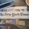  A photo illustration shows a cozy morning scene features the international edition of The New York Times alongside a cup of cappuccino with latte art and a notebook.