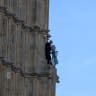  Man climbs Big Ben with a Palestinian flag.