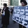  Haredi men are seen protesting the effort to draft ultra-Orthodox Israelis into the IDF.