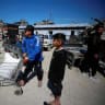  Palestinians gather to receive aid provided by UNRWA including food supplies, after Israel says it has ceased entry of humanitarian aid into Gaza, outside a distribution center, at Jabalia refugee camp in northern Gaza Strip, March 2, 2025. 