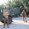 Members of the Lebanese army stand at the entrance of Deir Mimas, after an Israeli military spokesperson said on Monday that Israel would keep troops in several posts in southern Lebanon past a February 18 deadline for them to withdraw, in Deir Mimas, Lebanon February 18, 2025.