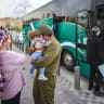  An IDF reservist kisses his child before boarding the bus, in Jerusalem, May 2025.