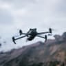  Drone flying on high altitude mountain top; illustrative.