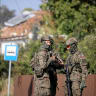 Soldiers patrol the street after a drone or similar object struck a residential building according to local authorities, following violations of Polish airspace during a Russian attack on Ukraine, in Wyryki-Polod, Poland September 10, 2025.