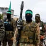 Palestinian Hamas terrorists stand guard on the day of the handover of hostages held in Gaza since the deadly October 7 2023 attack, as part of a ceasefire and a hostages-prisoners swap deal between Hamas and Israel, in Rafah in the southern Gaza Strip, February 22, 2025.