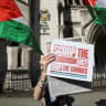 A person holds up a placard outside the Royal Courts of Justice, on the day judges decide whether the co-founder of Palestine Action can challenge the UK government's ban on the group, in London, Britain, September 25, 2025.