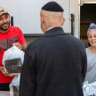 VOLUNTEERS PRESENT food packages to elderly people in Tel Aviv last year. The pleasure of giving often feels different from the fleeting rush of acquiring something for ourselves, the writer notes.
