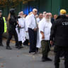 People gather near the scene, after an attack in which a car was driven at pedestrians and stabbings were reported near a synagogue in north Manchester, Britain, October 2, 2025.