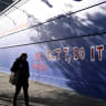 A man walks past a graffiti reading "Oct 7, do it again”' on a retail store in Melbourne, Australia, October 7, 2025.