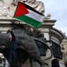 A protester holds a Palestinian flag during a protest to condemn the IDF’s interception of the Global Sumud Flotilla at the Place de la Republique in Paris, France, October 2, 2025