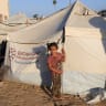 A Palestinian child looks on in front of a tent, amid a ceasefire between Israel and Hamas, in Gaza City, October 20, 2025