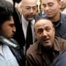 Marwan Barghouti is tightly guarded as he leaves a hearing at the Jerusalem Magistrate’s Court in 2012.