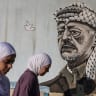 Palestinian women walk past a mural of Palestinian leader Yasser Arafat in Hebron on the 21st anniversary of Arafat’s death. Ruth Wasserman Lande argues that the Palestinian narrative was created by the Soviet Union. 