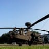 Members of the US Army perform maintenance on a Boeing AH-64 Apache attack helicopter, scheduled to be used in the US Army's 250th Birthday Celebration and Parade, following landing on the National Mall in Washington, DC, US, June 11, 2025.