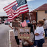Protesters opposing mass deportations by ICE hold signs during a protest held at the Cassidy Gate at Fort Bliss, the U.S. Army base where a large new ICE detention facility is being built, in El Paso, Texas, US, August 17, 2025.