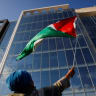 A demonstrator waves a Palestinian flag, during a protest against the U.S. backing of the Israeli military operation in Gaza, outside the Washington office of the American Israel Public Affairs Committee (AIPAC) in Washington, DC, US, September 22, 2025. 