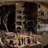 Emergency workers gather in the early hours of March 22, 2026 at the site of an Iranian missile strike hours earlier in Arad, Israel. Dozens were wounded in the strike, which Israel's air-defence system failed to intercept.