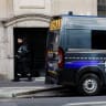 A private security member stands next to a police van outside Bank of America’s Paris offices, after French anti-terrorism prosecutors opened an investigation into attempted destruction by fire or other dangerous means in Paris, France, March 30, 2026. 