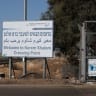 A view shows a sign as trucks carrying aid (not pictured) wait at the Israeli side of the Kerem Shalom border crossing to southern Gaza, October 20, 2025.