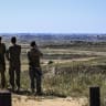 ISRAELI SOLDIERS look toward the northern Gaza Strip from an observation point near the Israeli border with the Gaza Strip in southern Israel, April 21, 2026.