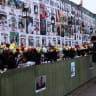 A man lights a candle by a wall showing pictures of protesters killed during anti-government demonstrations in Iran, in Golders Green, London, Britain, March 7, 2026. 