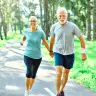 An elderly couple running in the forest