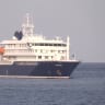 A boat beside cruise ship MV Hondius anchored off Cape Verde port, on the day sick passengers were evacuated by boat from the cruise ship, in Praia Port, Cape Verde, in this screengrab obtained from a video, May 5, 2026.